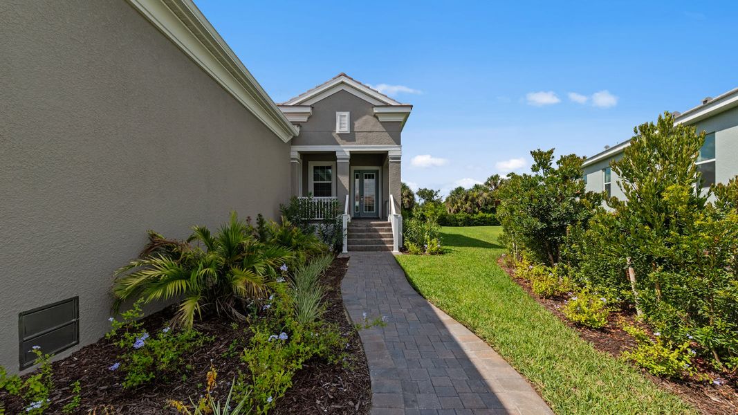 Front exterior of a new home in Verandah Real Estate and Homes for Sale in Fort Myers, FL - Neal Communities, Fort Myers, FL, highlighting curb appeal (Image 18).
