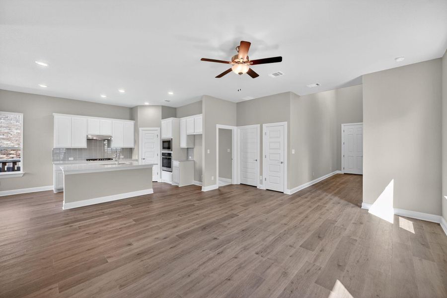 Unfurnished living room with recessed lighting, light wood-style floors, and ceiling fan Unfurnished living room with recessed lighting, light wood-style floors, and ceiling fan