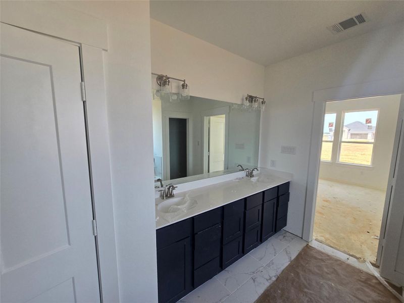 The elegant finishes, from the dazzling floors to the chic light fixtures, reflect a careful attention to detail that feels both luxurious and comforting.