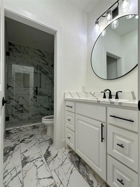 Bathroom with vanity, toilet, and walk in shower