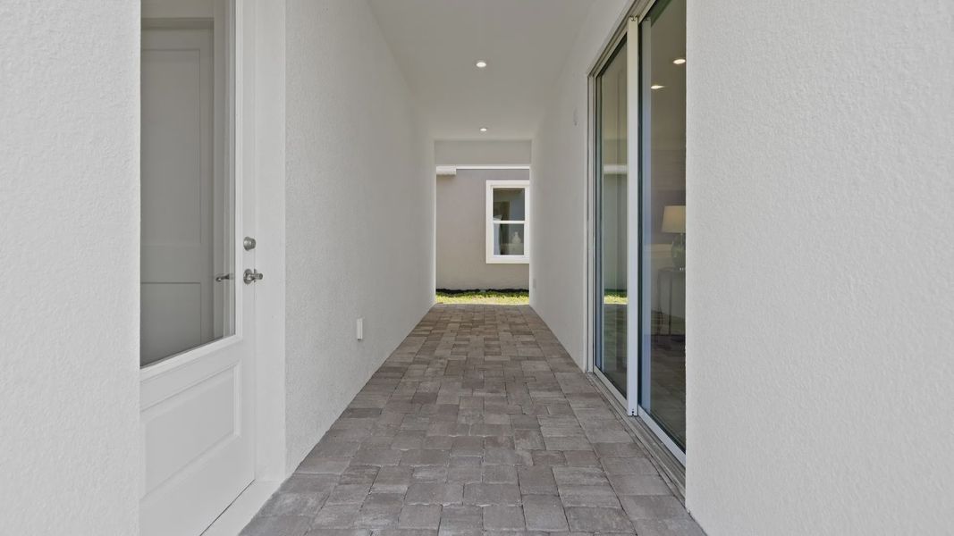 Outdoor lanai with access to garage and breakfast area in a DRB Homes Ambersweet model at Trinity Place. Outdoor lanai with access to garage and breakfast area in a DRB Homes Ambersweet model at Trinity Place.