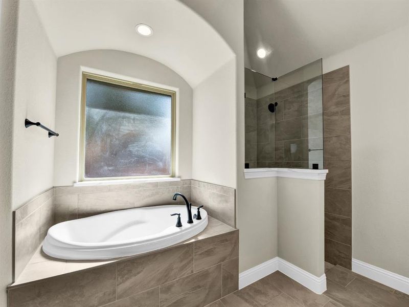 Bathroom featuring tile patterned flooring and plus walk in shower