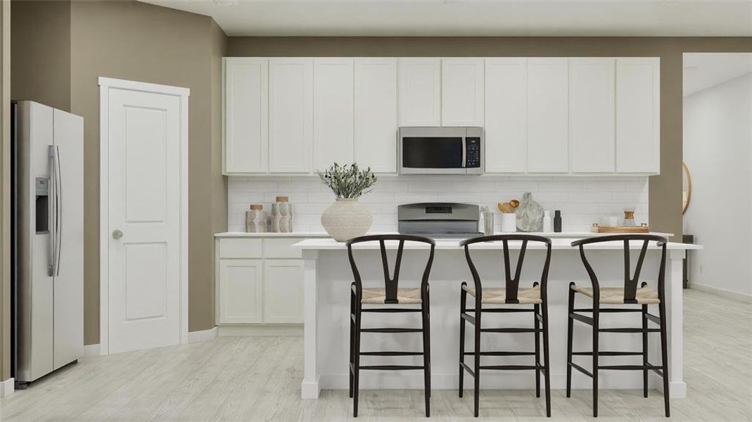 Kitchen with tasteful backsplash, white refrigerator with ice dispenser, stainless steel microwave, a kitchen island, and light wood finished floors