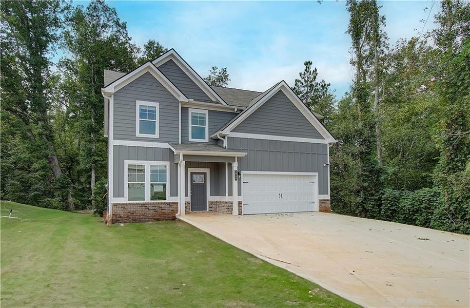 Front exterior of a new home in Berkeley Lakes, Locust Grove, GA, highlighting curb appeal (Image 18).