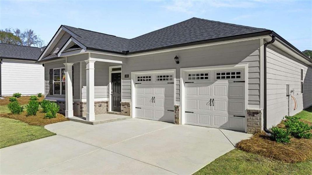 Front exterior of a new home in Oakchase at Hampton, Hampton, GA, highlighting curb appeal (Image 21). Front exterior of a new home in Oakchase at Hampton, Hampton, GA, highlighting curb appeal (Image 21).