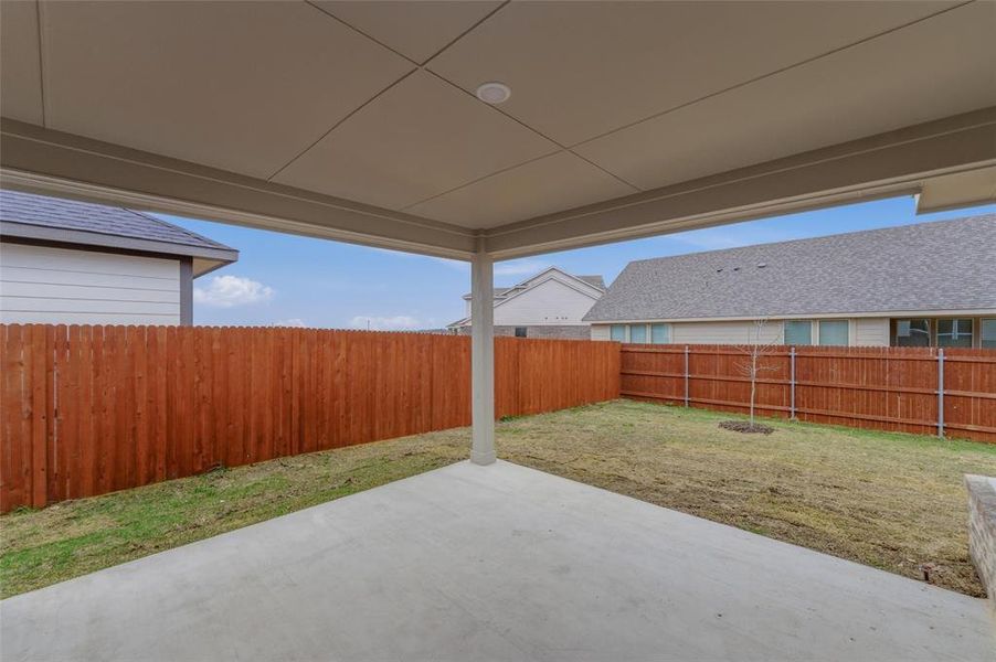 Fenced backyard featuring a patio area