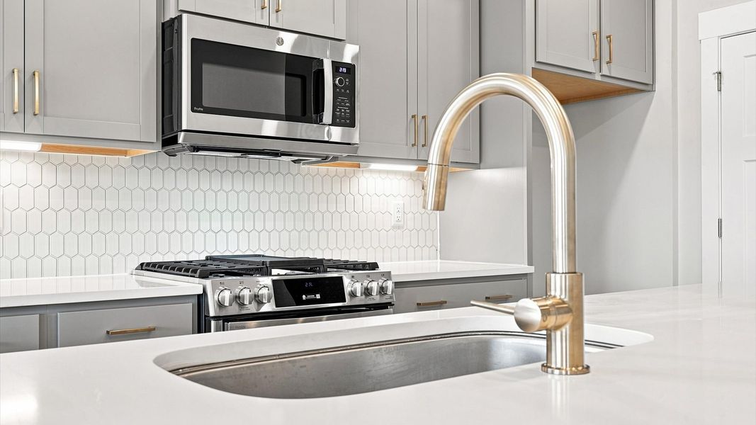 Vibrant kitchen layout with a center island, refined finishes, and open-concept flow Vibrant kitchen layout with a center island, refined finishes, and open-concept flow