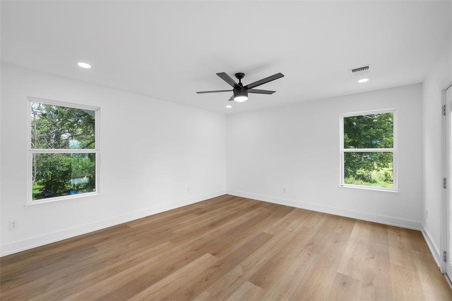 Empty room with recessed lighting, ceiling fan, and light wood-style floors Empty room with recessed lighting, ceiling fan, and light wood-style floors