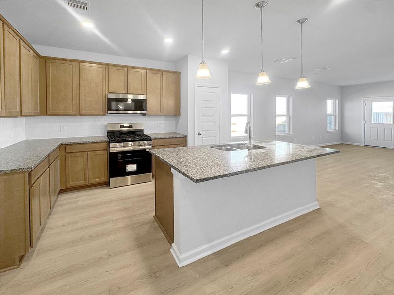 The Waring III- Kitchen into Family Room. Under construction, options, upgrades and colors will vary.