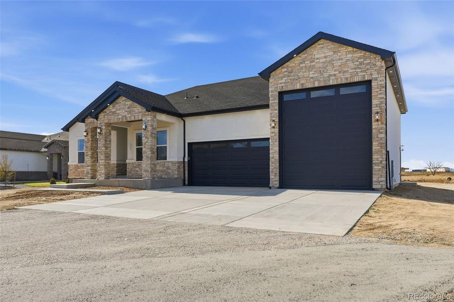 Front exterior of a new home in , Keenesburg, CO, highlighting curb appeal (Image 26).