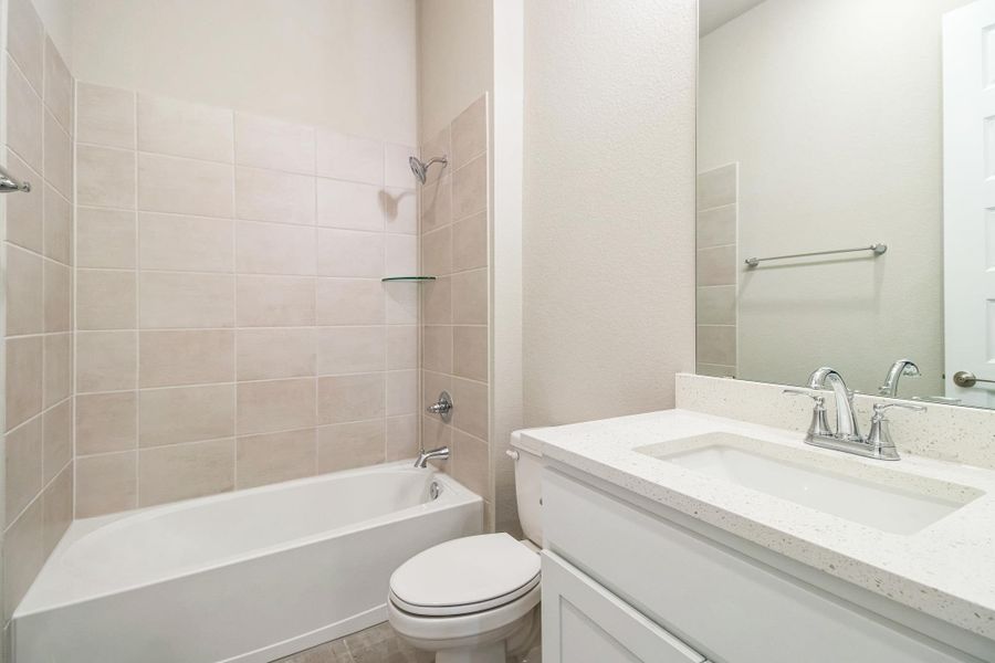 Full bath featuring toilet, shower / washtub combination, and vanity Full bath featuring toilet, shower / washtub combination, and vanity