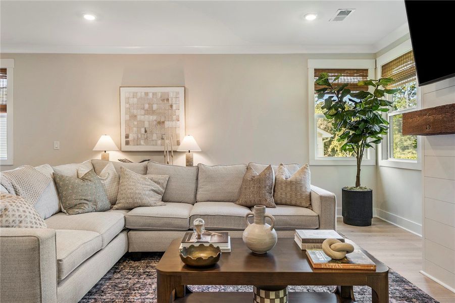 This inviting living area boasts natural light and This inviting living area boasts natural light and
