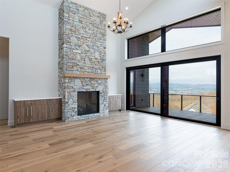 Family Room with Floor to Ceiling Stacked Stone Natural Gas Fireplace