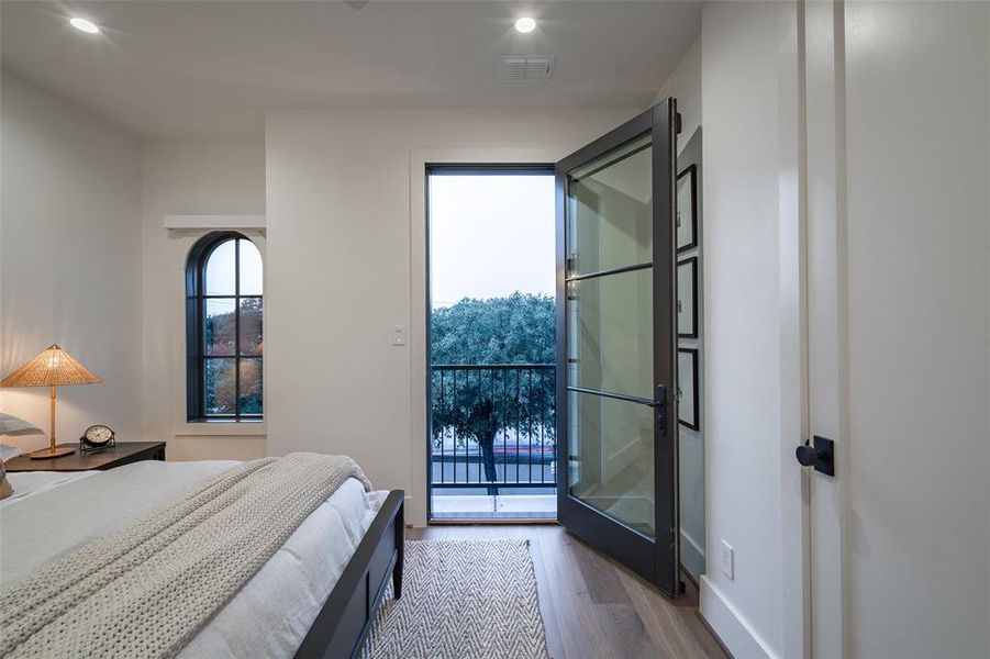 Bedroom featuring access to exterior and light hardwood / wood-style flooring