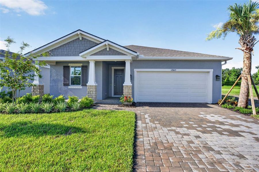 Front exterior of a new home in Windwater, Parrish, FL, highlighting curb appeal (Image 1). Front exterior of a new home in Windwater, Parrish, FL, highlighting curb appeal (Image 1).