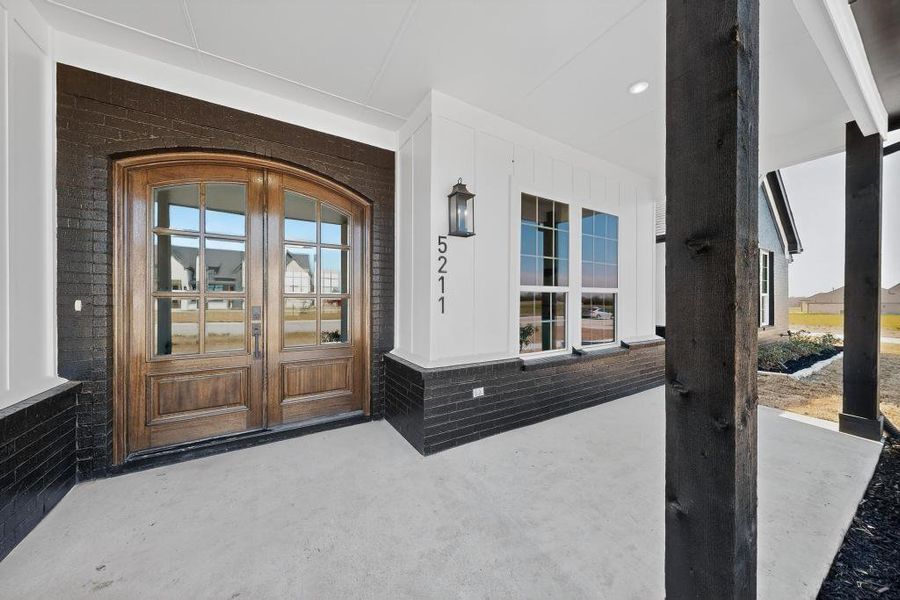 Doorway to property featuring a porch and french doors