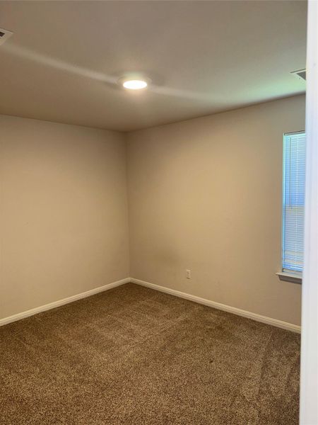 Neutral tone wall paint, textured carpet flooring, recessed ceiling lighting, and a window with horizontal blinds Neutral tone wall paint, textured carpet flooring, recessed ceiling lighting, and a window with horizontal blinds