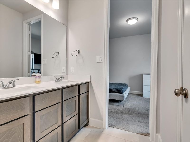 Spacious bathroom with a double vanity, modern fixtures, and full bathroom.