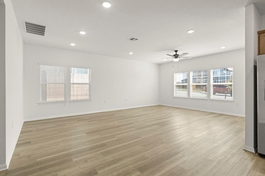 Empty room with light wood-type flooring, recessed lighting, and a ceiling fan