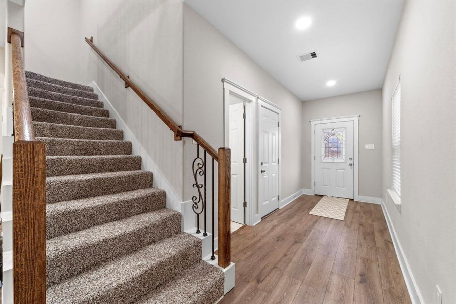Elegant wrought iron staircase with rich wood accents adds timeless architectural charm.