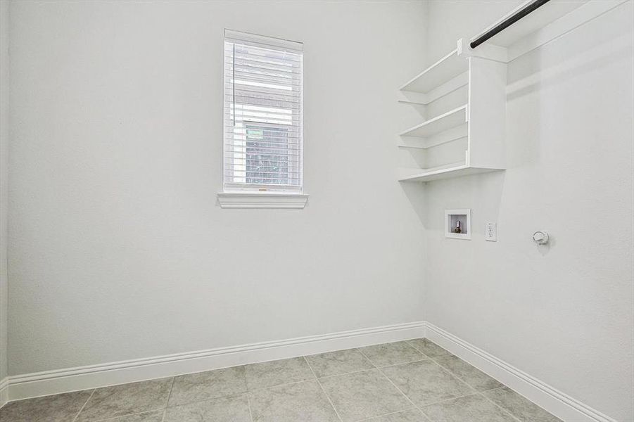 Laundry room featuring hookup for a gas dryer, hookup for a washing machine, and light tile patterned floors