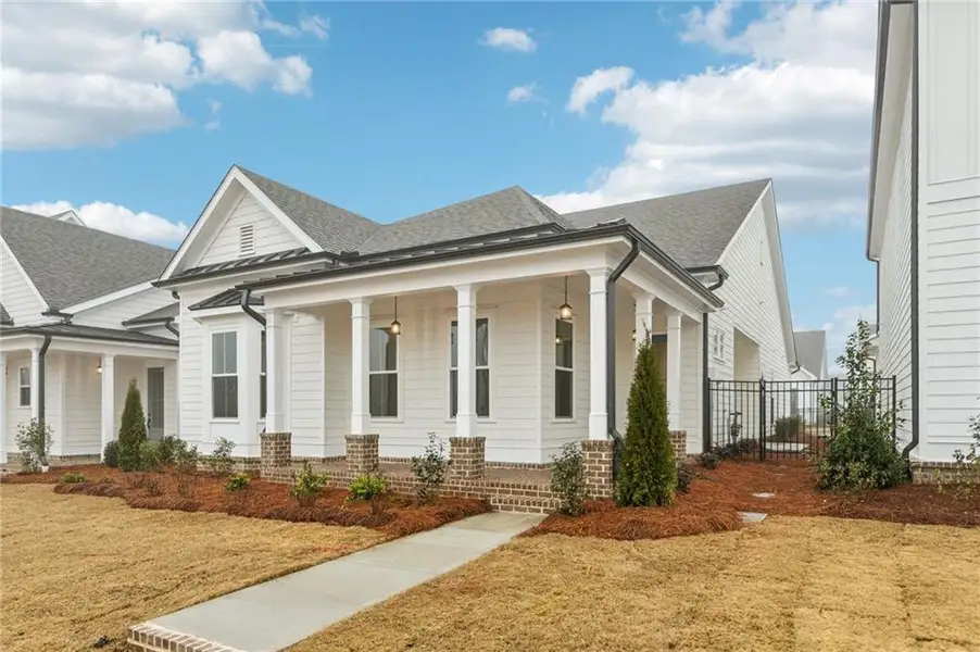 Front exterior of a new home in Promenade at Sawnee Village, Cumming, GA, highlighting curb appeal (Image 20).