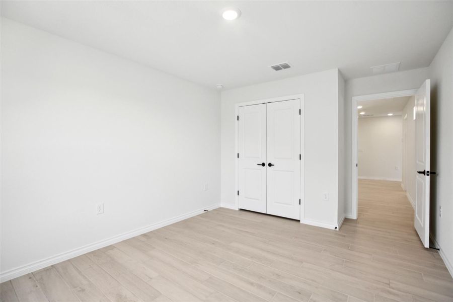 Unfurnished bedroom featuring recessed lighting, light wood-type flooring, and a closet