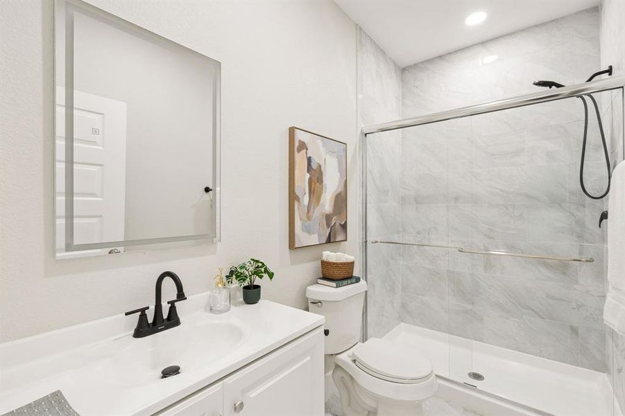 Contemporary bathroom featuring a white vanity with integrated sink, matte black faucet, and a large illuminated mirror Contemporary bathroom featuring a white vanity with integrated sink, matte black faucet, and a large illuminated mirror