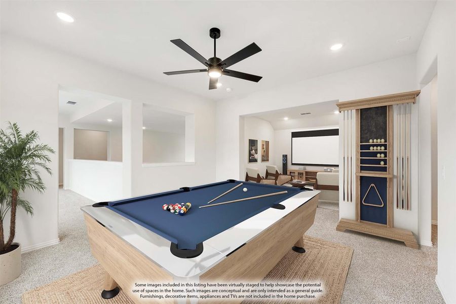 Game room with pool table, cue rack, ceiling fan, and home theater area in background