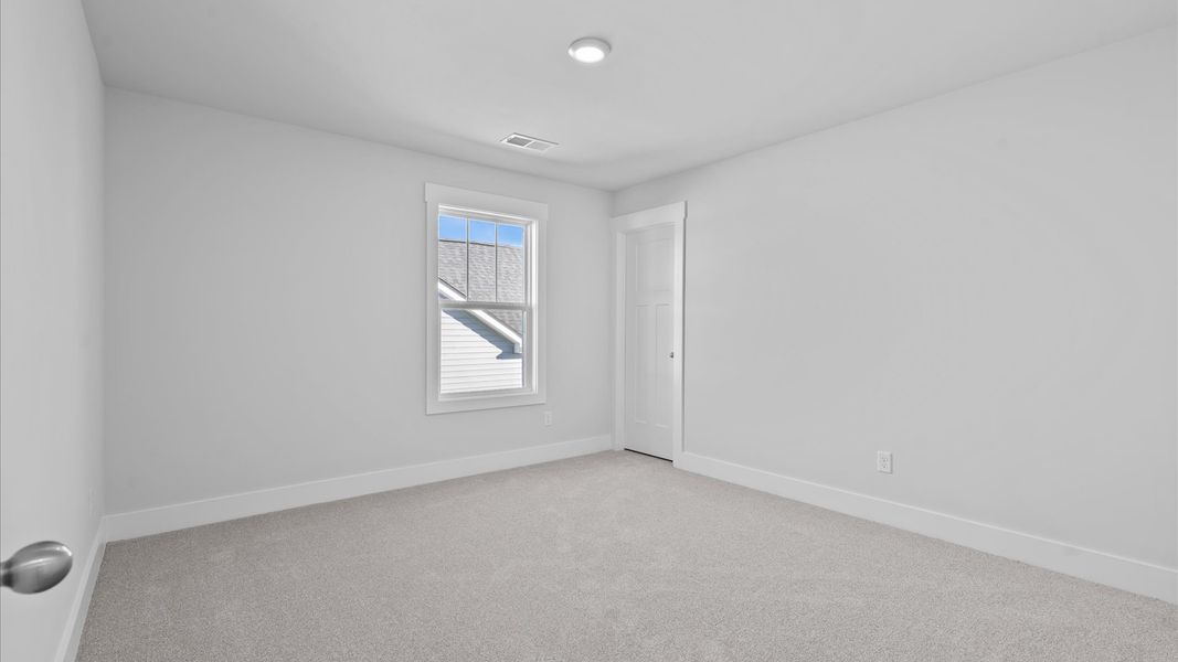 Superior comfort in this light-filled bedroom with plush carpeting and thoughtfully placed large windows
