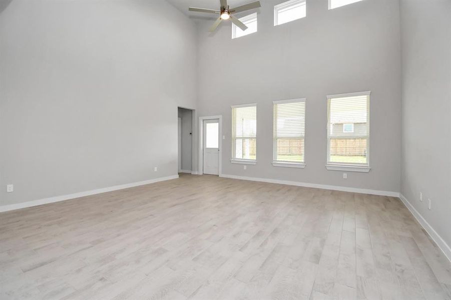 Another view of family room with high ceilings. Sample photo of completed home with similar floor plan. Actual colors and selections may vary.