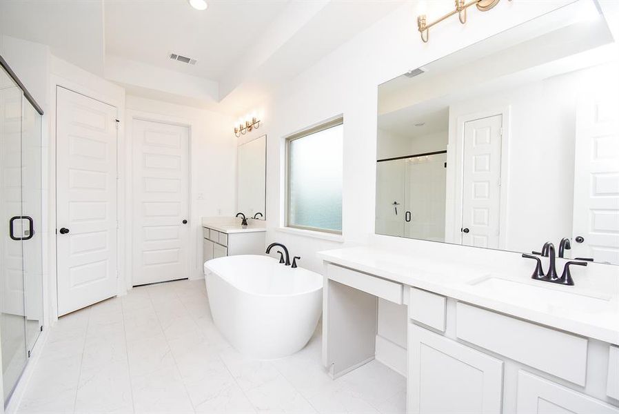 The spacious layout is complemented by a generous closet that conveniently leads to the laundry room, enhancing functionality and ease of use. This combination makes the bathroom not only a serene space but also a practical one for daily living.