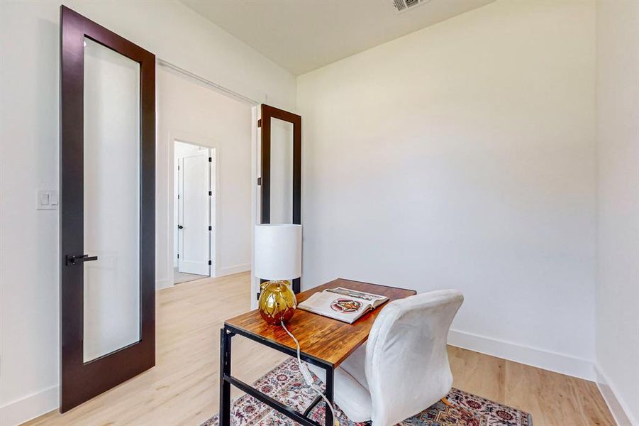 Hall Half Bathroom featuring vanity with extensive cabinet space and toilet