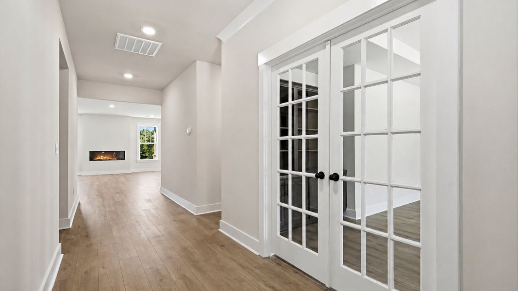 Highly functional foyer with hardwood flooring that flows seamlessly into living spaces