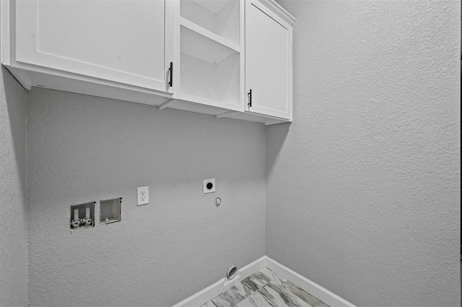 Laundry room featuring electric dryer hookup, washer hookup, and cabinets