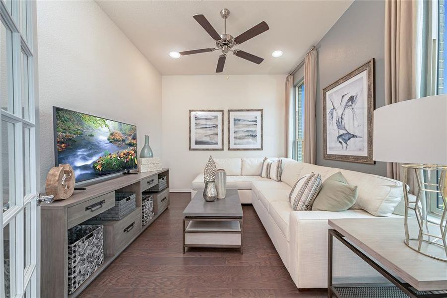 Living area with dark wood-style flooring, ceiling fan, and recessed lighting