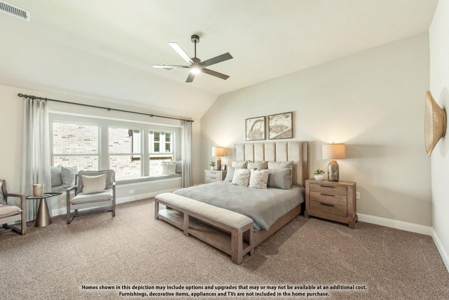 Spacious master bedroom with vaulted ceiling, ceiling fan, carpet flooring, and window seat
