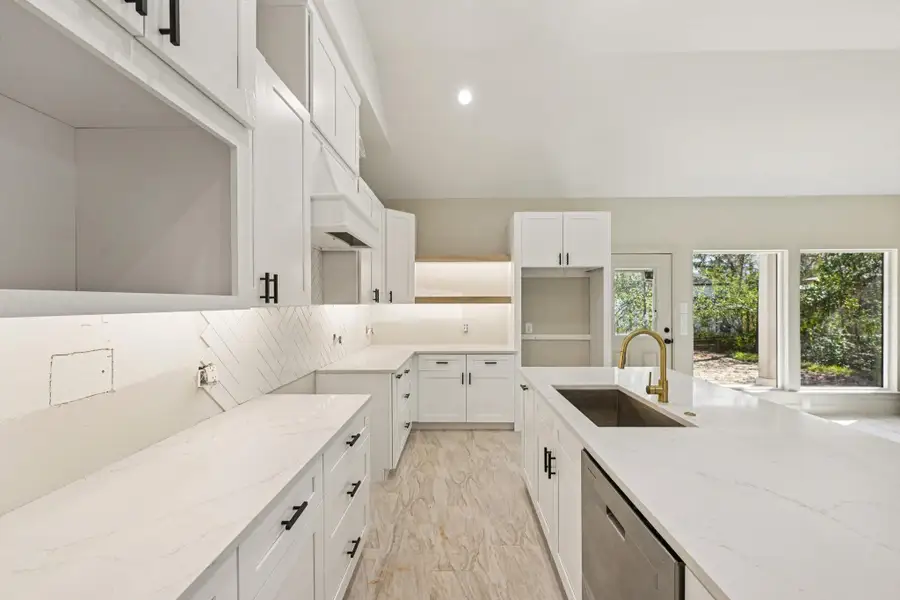 get a closer look at the modern kitchen,  elegant gold fixtures.