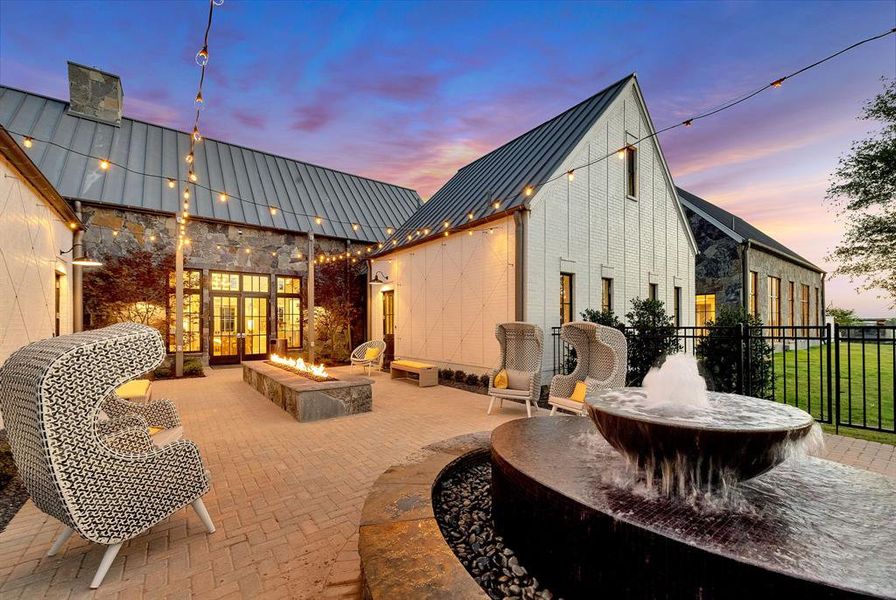 Patio terrace at dusk with an outdoor fire pit and a patio Patio terrace at dusk with an outdoor fire pit and a patio
