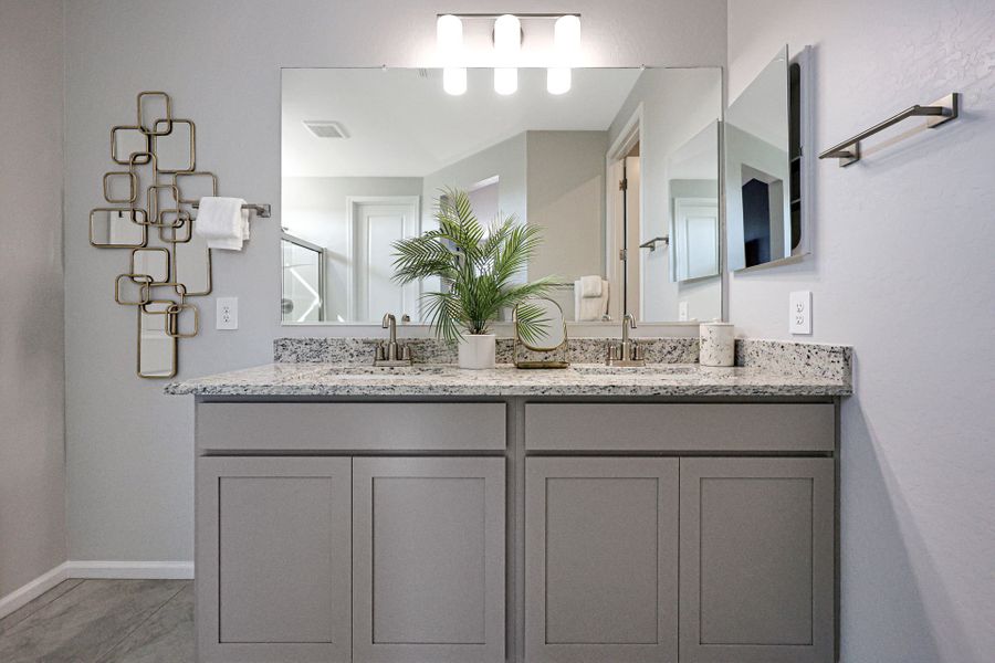A bathroom with a large mirror.
