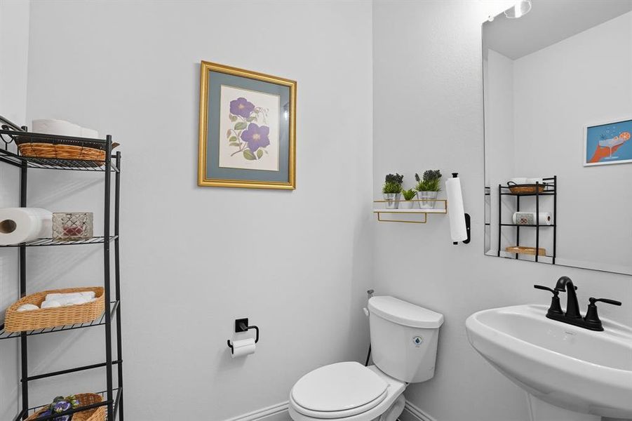 Bathroom featuring toilet and baseboards