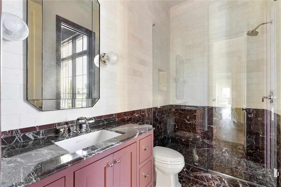 Full bathroom featuring tile walls, a stall shower, and vanity Full bathroom featuring tile walls, a stall shower, and vanity