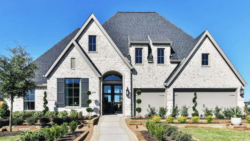 Front exterior of a new home in Valencia, Manvel, TX, highlighting curb appeal (Image 2). Front exterior of a new home in Valencia, Manvel, TX, highlighting curb appeal (Image 2).
