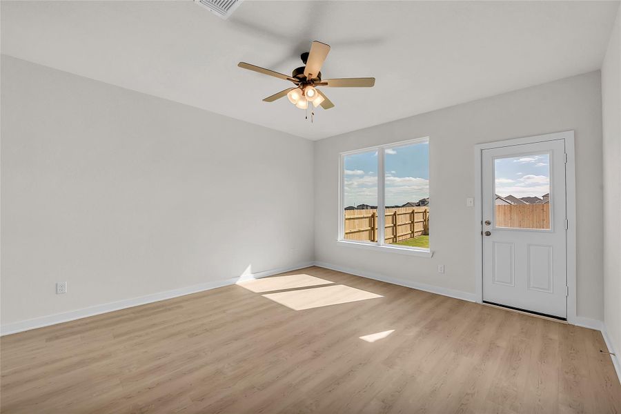 Empty room with light wood-style flooring and a ceiling fan