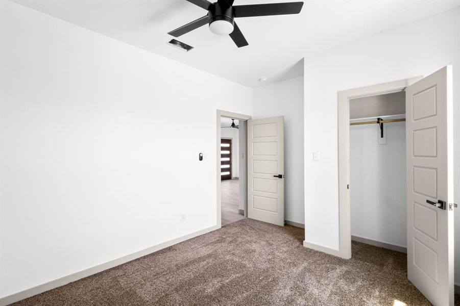 Unfurnished bedroom featuring baseboards, visible vents, carpet, a closet, and ceiling fan Unfurnished bedroom featuring baseboards, visible vents, carpet, a closet, and ceiling fan