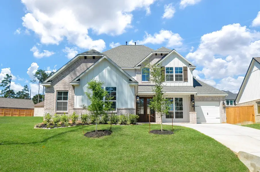 Front exterior of a new home in Mostyn Manor Reserve, Magnolia, TX, highlighting curb appeal (Image 2).