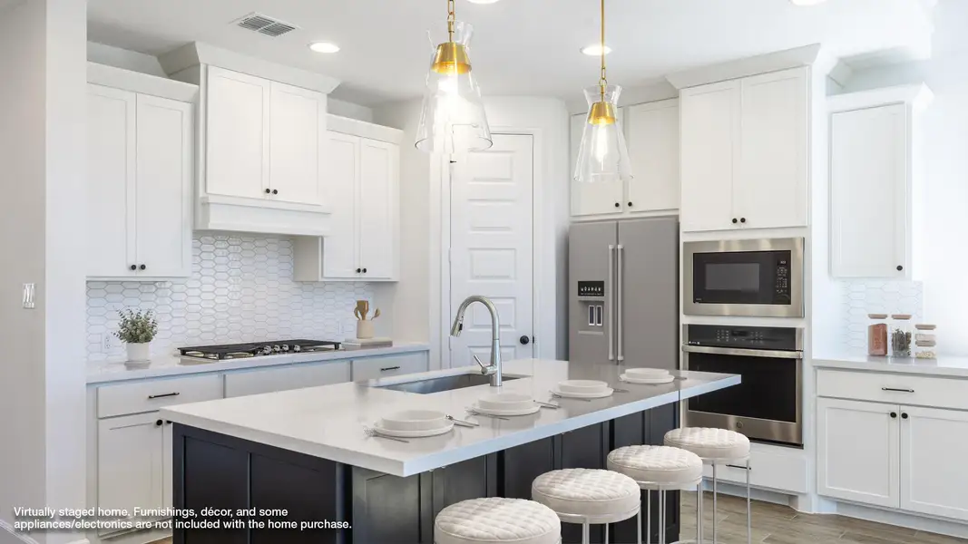 Kitchen with backsplash, appliances with stainless steel finishes, light stone counters, recessed lighting, and white cabinets