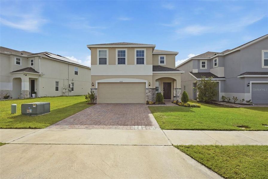 Front exterior of a new home in , Kissimmee, FL, highlighting curb appeal (Image 1). Front exterior of a new home in , Kissimmee, FL, highlighting curb appeal (Image 1).