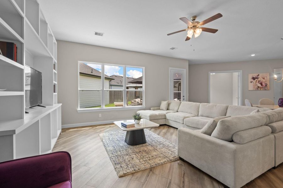 The Promenade III living room is bathed in natural light, offering a bright, open space perfect for relaxing or entertaining family and friends. Image depicts home as-is.