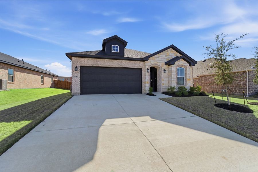 Front exterior of a new home in Pebblebrook, Sherman, TX, highlighting curb appeal (Image 2).